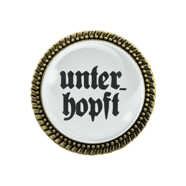 Gaudi-Brosche mit dem Spruch 'Unterhopft' – Perfekt als Geschenk für Oktoberfest und Trachtenfeste.